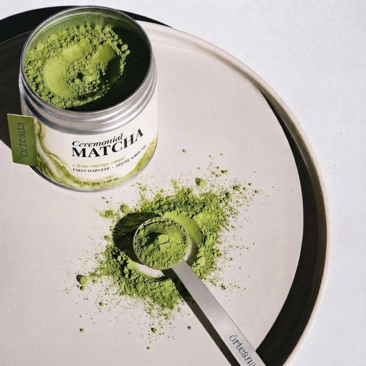 Prepared ORTEANA ceremonial matcha beside a laptop and newspaper during a morning ritual.